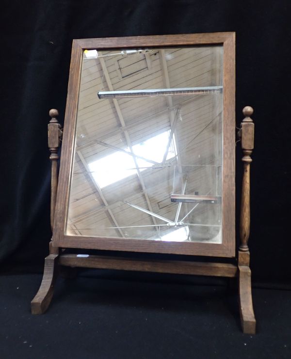 AN OAK-FRAMED DRESSING TABLE MIRROR OF SMALL PROPORTIONS