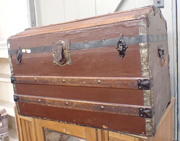 A DOME-TOPPED CANVAS COVERED AND WOOD-BOUND TRUNK