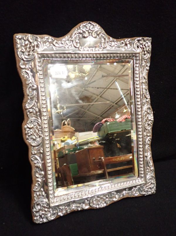 A SILVER FRAMED EDWARDIAN MIRROR