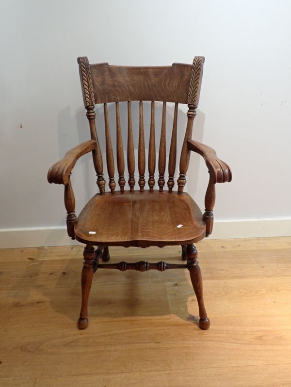 AN ARTS AND CRAFTS STYLE OAK ARM CHAIR