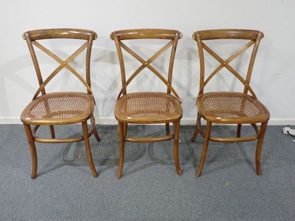 A SET OF THREE BEECH AND CANED BENTWOOD DINING CHAIRS