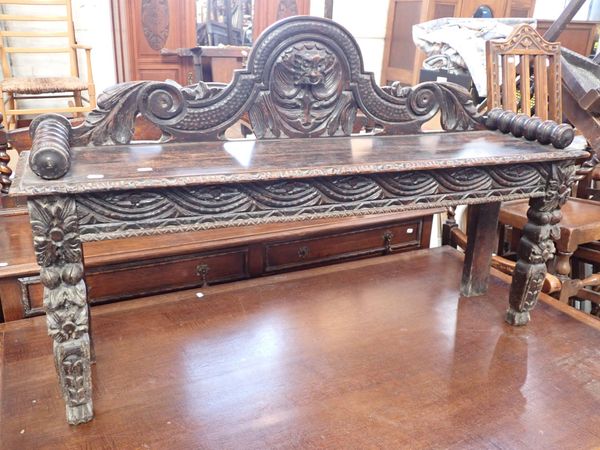 A VICTORIAN CARVED OAK HALL SEAT