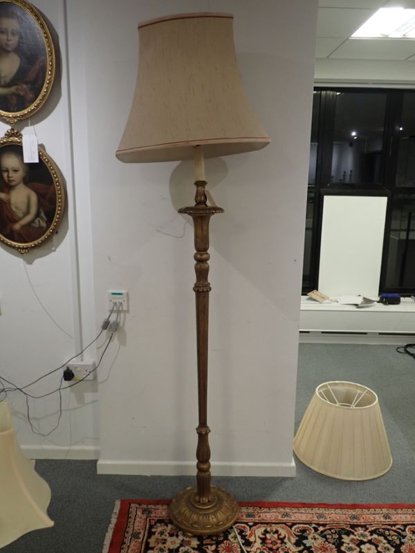 A CARVED AND GILTWOOD STANDARD LAMP