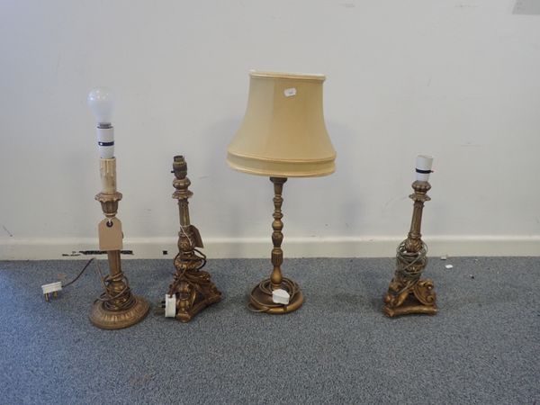 A GROUP OF FOUR CARVED GILTWOOD AND COMPOSITION LAMP BASES