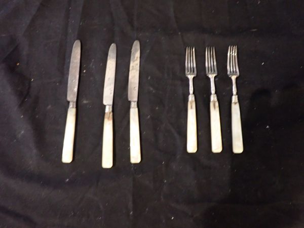 A SET OF SIX SILVER AND MOTHER OF PEARL DESSERT KNIVES AND FORKS