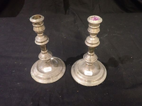 A PAIR OF SILVER CANDLESTICKS