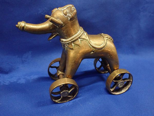 A CAST BRASS ELEPHANT ON WHEELS, POSSIBLY BURMESE