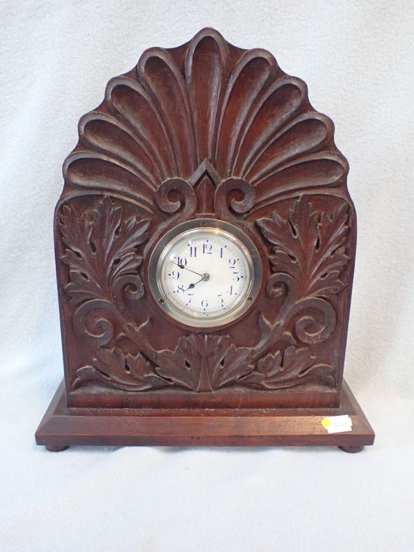 AN EARLY 20TH CENTURY CARVED MAHOGANY CASED CLOCK