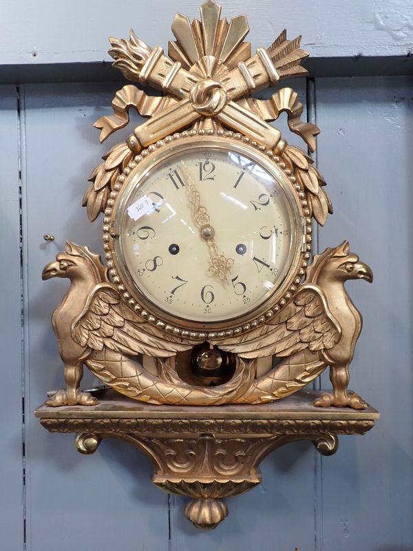 A SWEDISH EMPIRE STYLE CARTEL CLOCK, IN CARVED GILTWOOD CASE