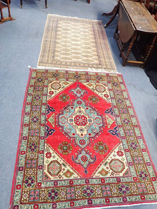 A RED PERIAN RUG WITH A 'GOLD' AFGHAN RUG