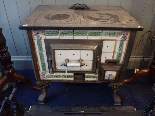 A CONTINTENTAL KITCHEN STOVE WITH CERAMIC TILE PANELS