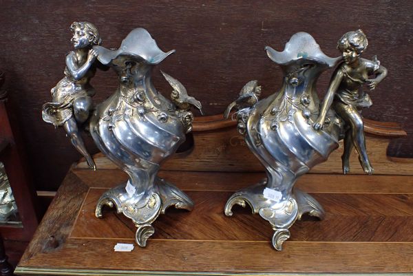 A PAIR OF ART NOUVEAU SILVERED AND GILT SPELTER VASES WITH FIGURAL DECORATION