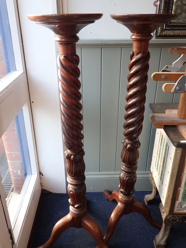 A PAIR OF CARVED AND SPIRAL-TURNED MAHOGANY TORCHERES