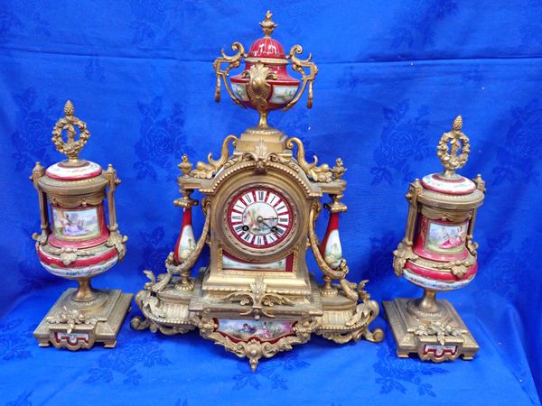 A FRENCH GILT SPELTER AND PORCELAIN CLOCK GARNITURE