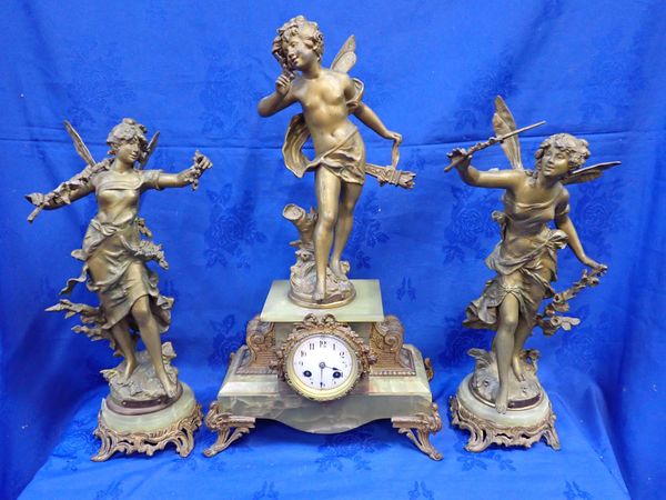 A FRENCH GILT SPELTER AND ONYX CLOCK GARNITURE