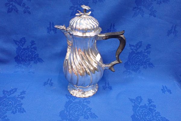 A SILVER COFFEE POT OF WRYTHEN FORM, THE SPOUT OF CONFORMING PROFILE