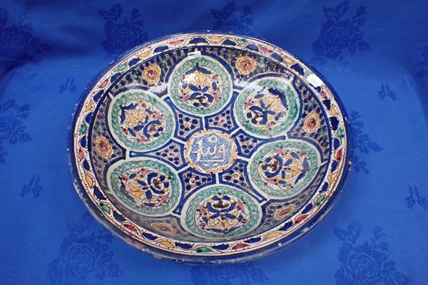 A MIDDLE EASTERN EARTHENWARE DISH, WITH POLYCHROME DECORATION