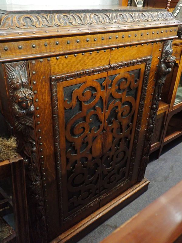 A VICTORIAN CARVED OAK CABINET
