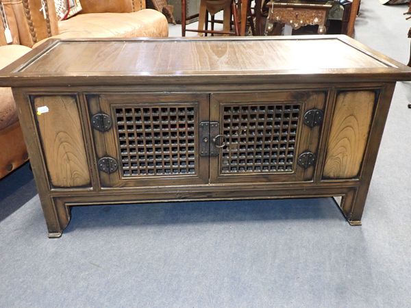 AN ORIENTAL ELM LOW CUPBOARD