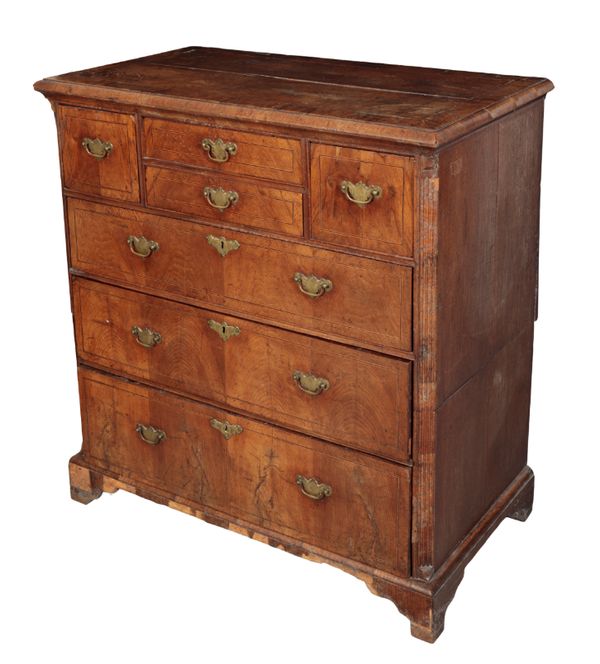 AN EARLY GEORGE II WALNUT AND OAK CHEST OF DRAWERS