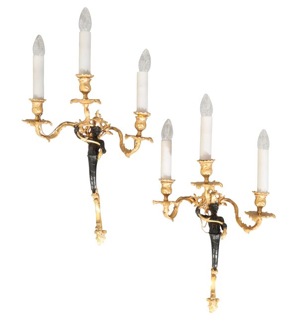 A SET OF THREE GILT METAL FIGURAL WALL LIGHTS