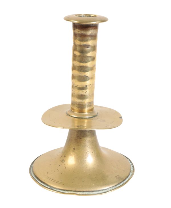 A CHARLES II BRASS TRUMPET CANDLESTICK