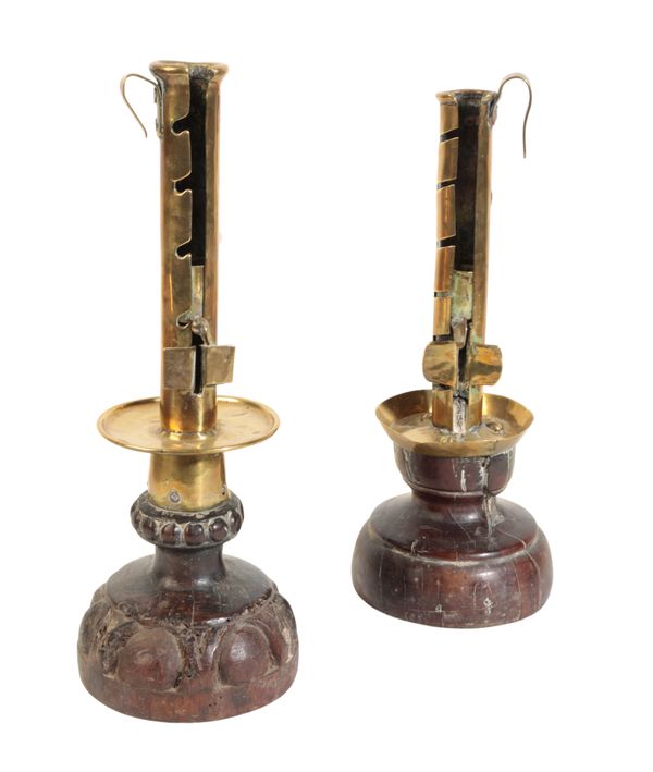 A MATCHED PAIR OF 17TH CENTURY BRASS AND CARVED WOOD CANDLESTICKS