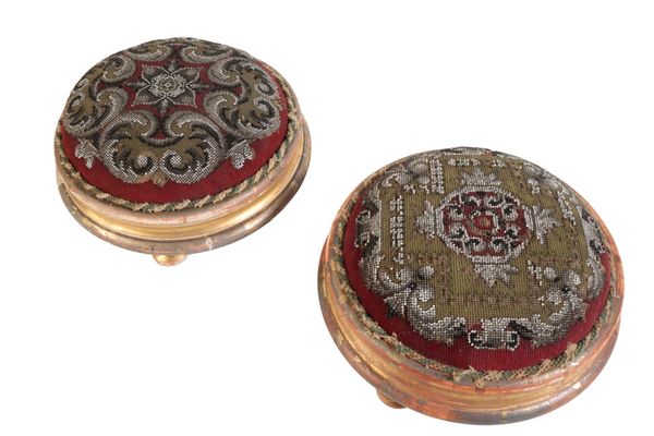 A MATCHED PAIR OF VICTORIAN GILTWOOD FRAMED FOOTSTOOLS