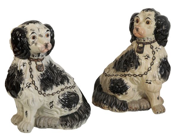 A NEAR PAIR OF LARGE STAFFORDSHIRE TYPE POTTERY SPANIELS