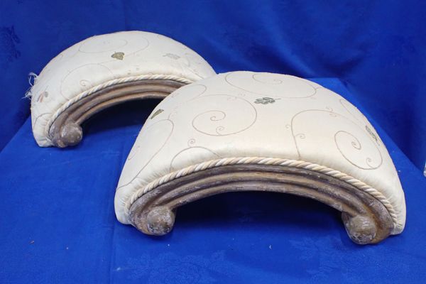 A PAIR OF FOOTSTOOLS, IN THE FORM OF 'C' SCROLLS