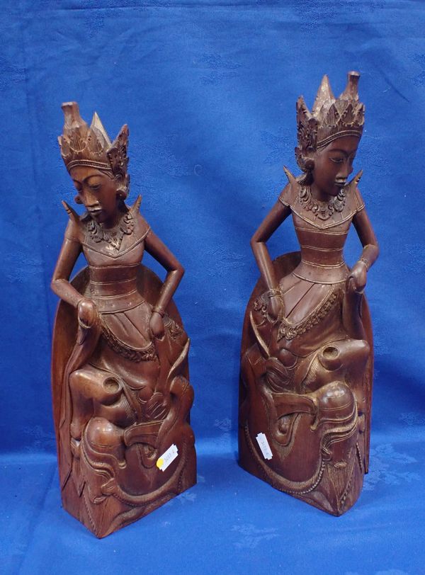 A PAIR OF BALINESE CARVED HARDWOOD BOOKENDS, BY A. A. FATIMAH