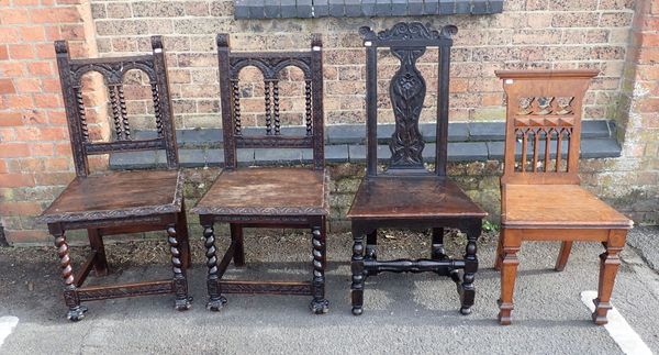 A PAIR OF GOTHIC STYLE OAK HALL CHAIRS