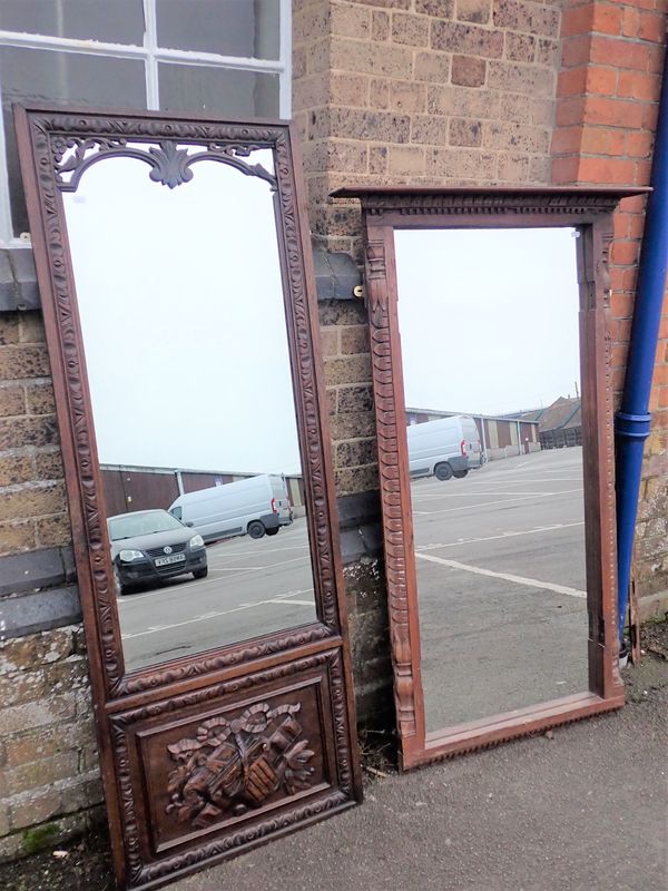 A CARVED OAK FRAMED WALL MIRROR