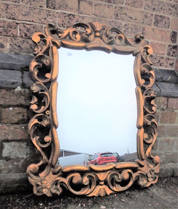 A CARVED AND GILTWOOD FRAMED ROCOCO STYLE MIRROR