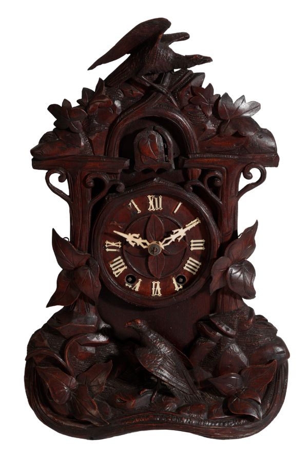 AN EDWARDIAN BLACK FOREST MANTEL CLOCK