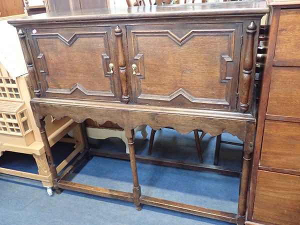 A 17TH CENTURY STYLE OAK CUPBOARD ON STAND