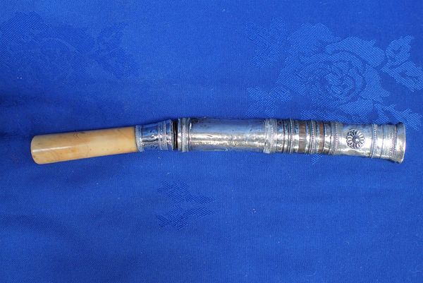 AN EASTERN SHORT DAGGER OR KRIS, WITH WHITE METAL SCABBARD