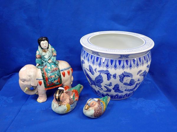 A ORIENTAL STYLE JARDINERE WITH A CERAMIC WOMAN RIDING AN ELEPHANT