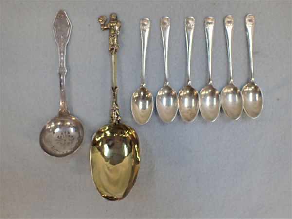 A GILT SPOON WITH FIGURAL TERMINAL AND INDISTINCT MARKS