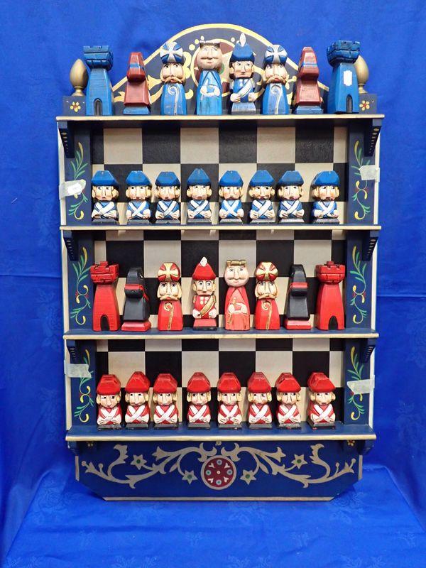 A CARVED AND PAINTED RUSTIC STYLE CHESS SET