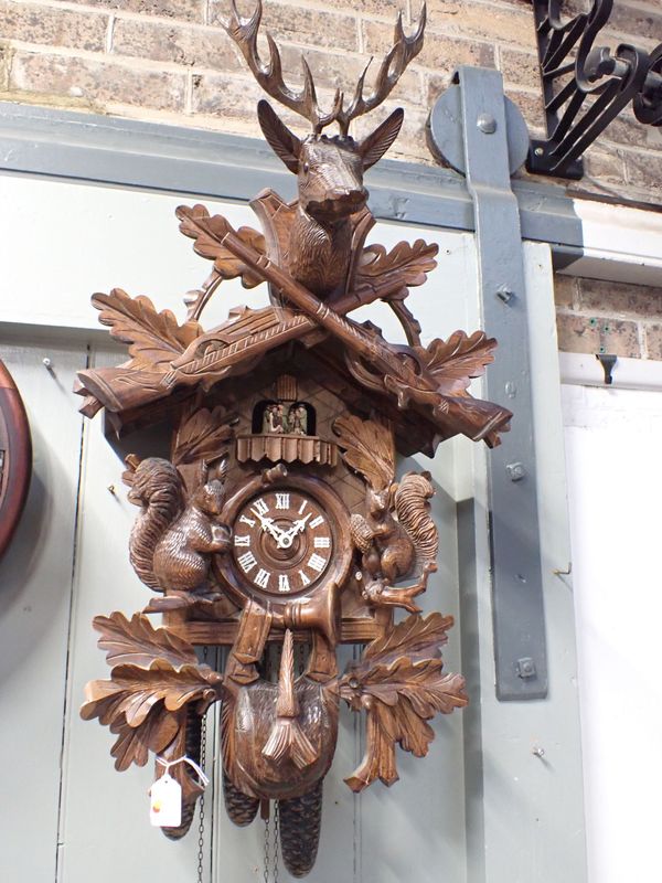 A THREE-TRAIN  REUGE CUCKOO CLOCK, WITH REVOLVING FIGURES AND MUSICAL MOVEMENT