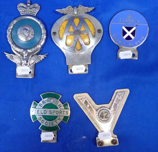 A COLLECTION OF CAR BADGES