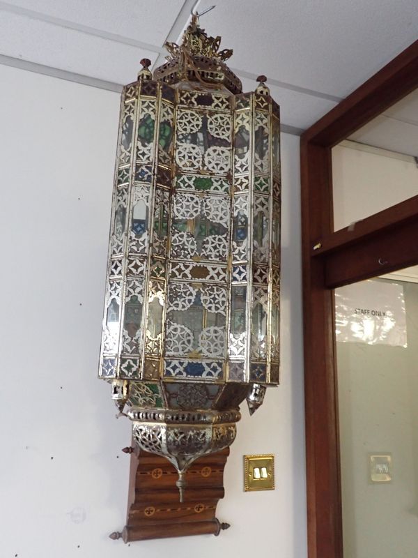 A MOROCCAN STYLE BRASS FRAMED GLAZED HANGING LANTERN