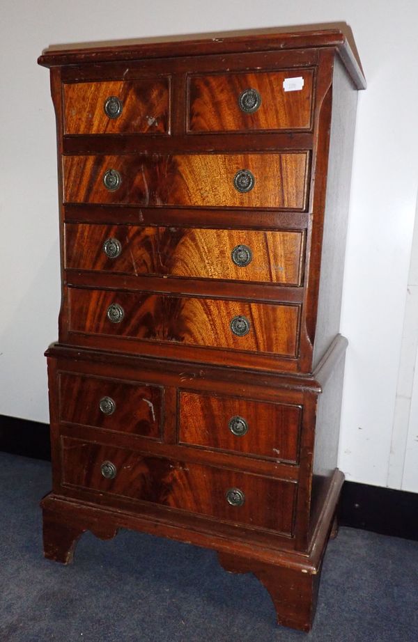 A REPRODUCTION MAHOGANY MINIATURE CHEST-ON-CHEST