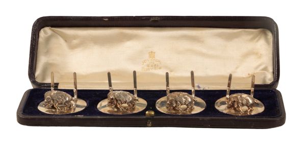 A SET OF FOUR SILVER MENU HOLDERS