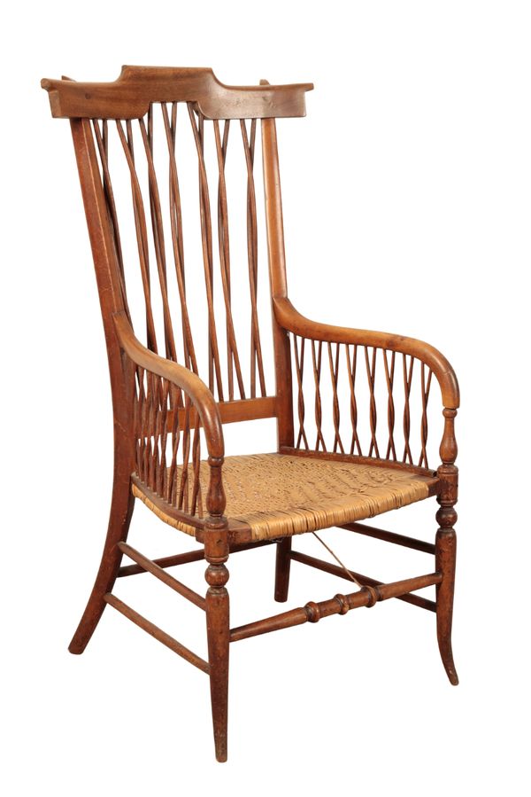 AN EDWARDIAN COMB BACK ARMCHAIR