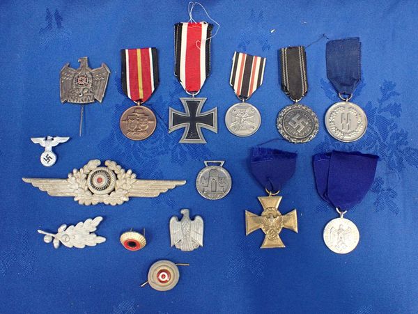 A COLLECTION OF NAZI STYLE MEDALS AND BADGES