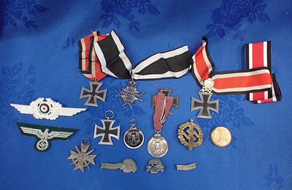 A COLLECTION OF NAZI STYLE MEDALS AND BADGES