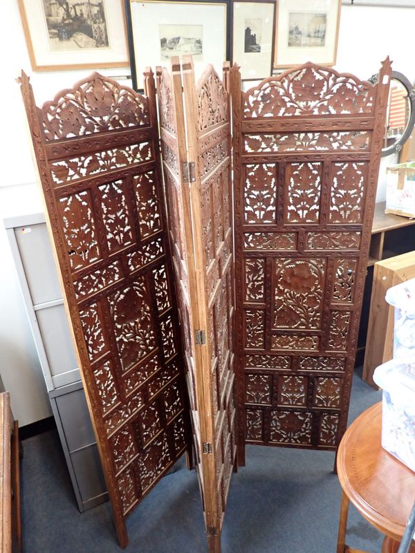 AN INDIAN CARVED HARDWOOD FOUR-PANEL SCREEN