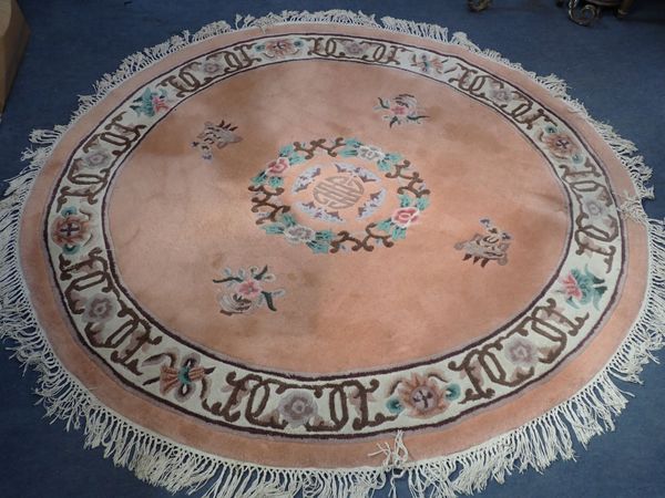 A PEACH GROUND OVAL CHINESE RUG